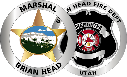 Two circular emblems: left says “MARSHAL” and “BRIAN HEAD” with a landscape in a star; right says “HEAD FIRE DEPT” and “UTAH” with a firefighter crest and helmet.