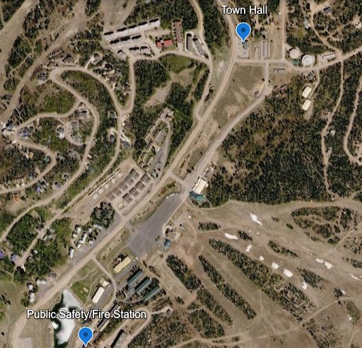 Satellite map with markers for Town Hall and Public Safety/Fire Station near connecting roads and woodland.