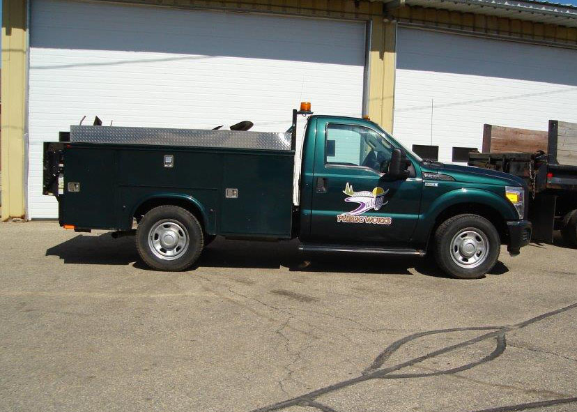 Dark green Ford Super Duty service truck