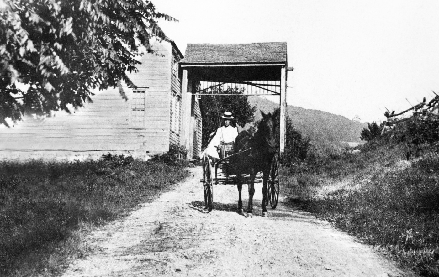Horse-drawn cart through a covered passageway