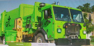 Bright green GFL Environmental (Green for Life) automated side-loader garbage truck