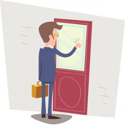 Person standing by a red door, touching the window frame with one hand.