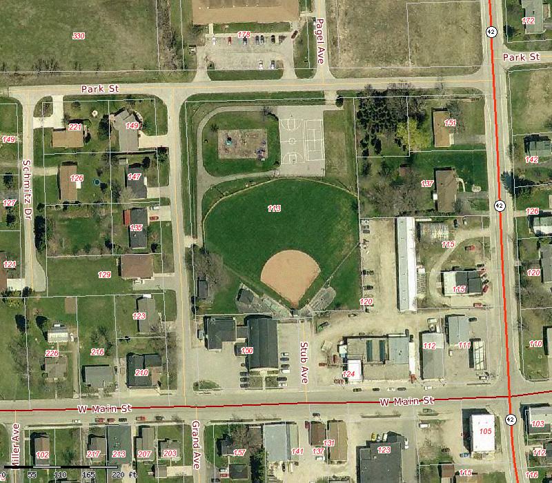Aerial map of numbered parcels along W Main St, Park St, Schultz Rd, and Bagley Ave with a red boundary highlight near the right edge.